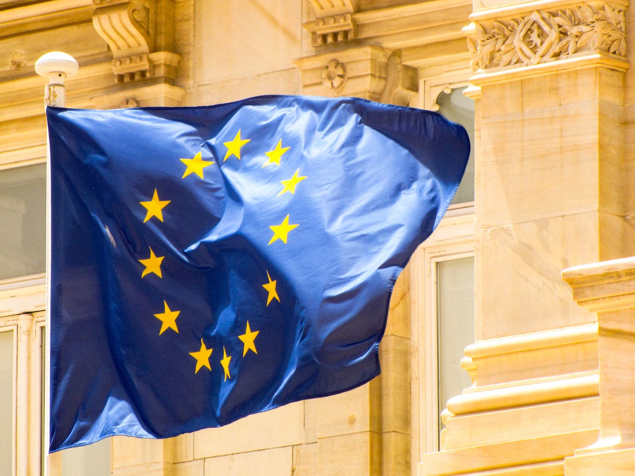gallery-5 Bright European Union flag waving against historic architecture in Cartagena, Spain.