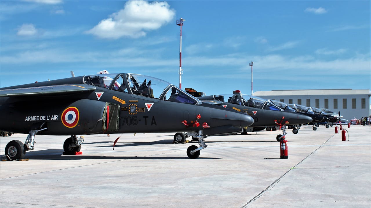 services-03 Line of French Air Force jets on a sunny runway in Malta, ready for operations.
