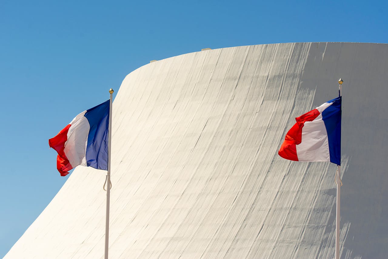 gallery-1 Two French flags waving in front of modern architecture in Le Havre, France.