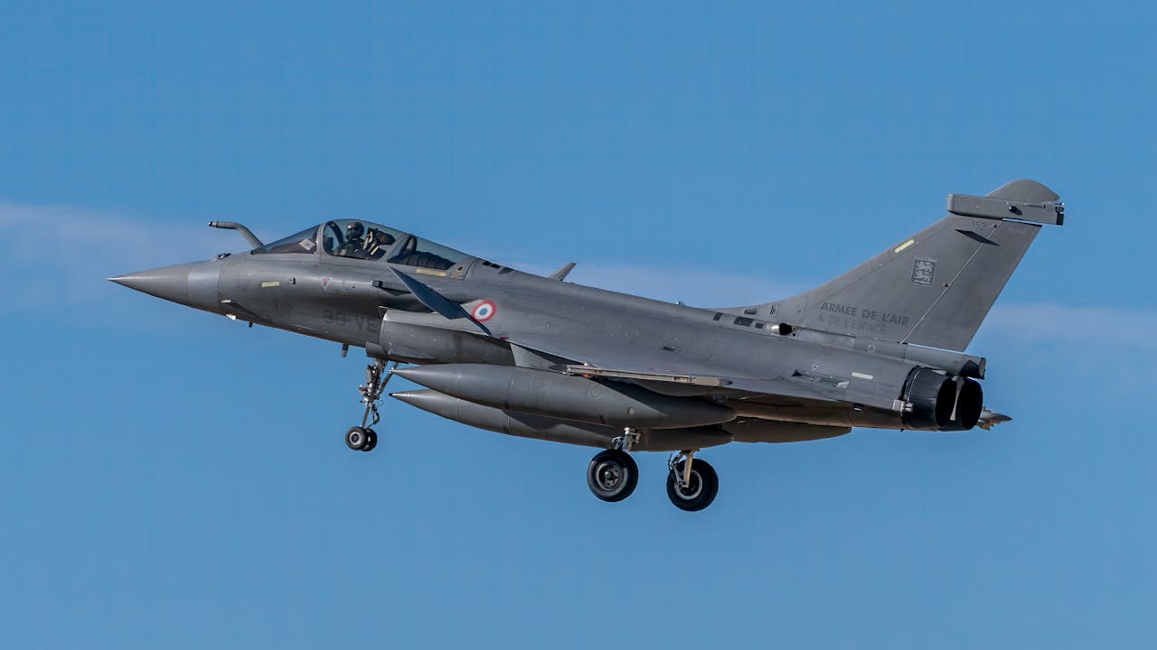 why-choose-us A French Rafale fighter jet flying under a clear blue sky in Los Llanos, Spain.